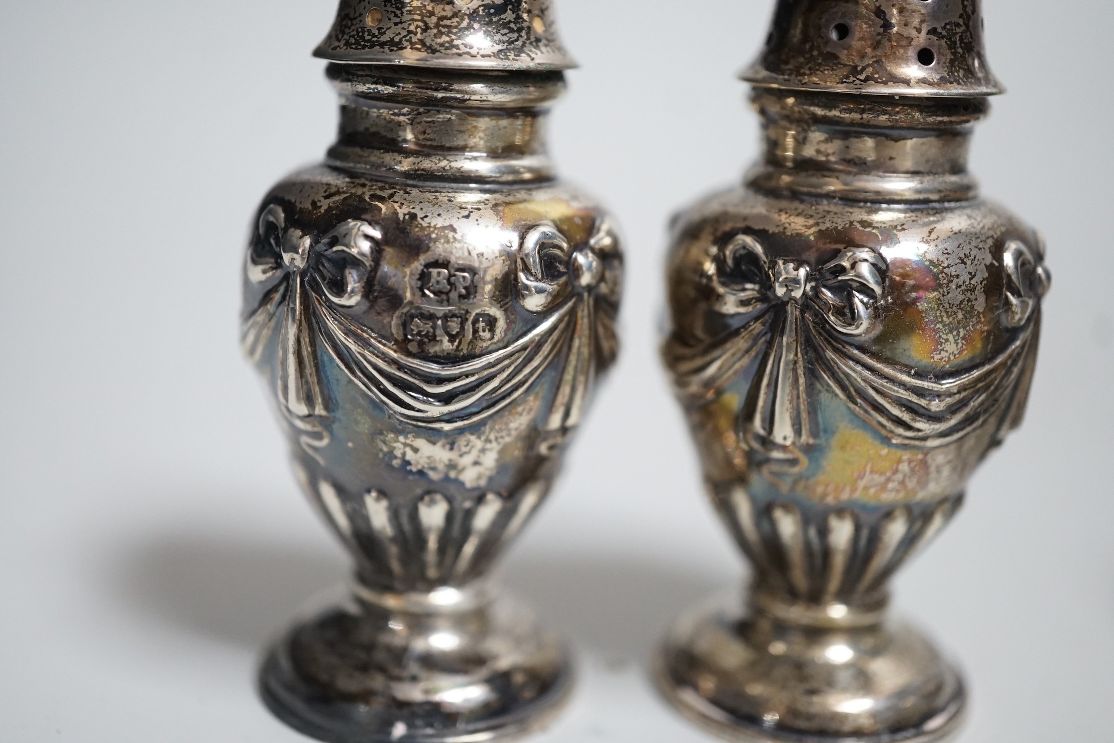 A pair of Victorian silver bun salts, London, 1868, diameter 5cm and a pair of Victorian silver peppers.